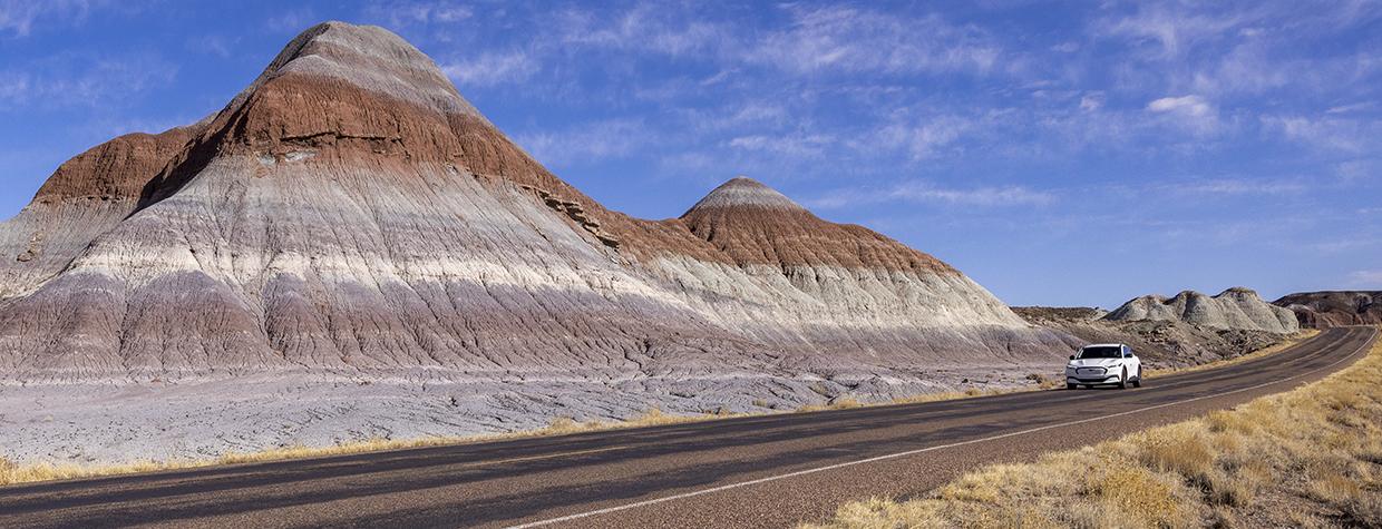 Author Noah Austin navigates an electric vehicle through the Tepees, a section of Petrified Forest National Park. While Arizona’s other two national parks, Grand Canyon and Saguaro, have fast charging stations nearby, the Petrified Forest area poses challenges for EV road-trippers. | John Burcham