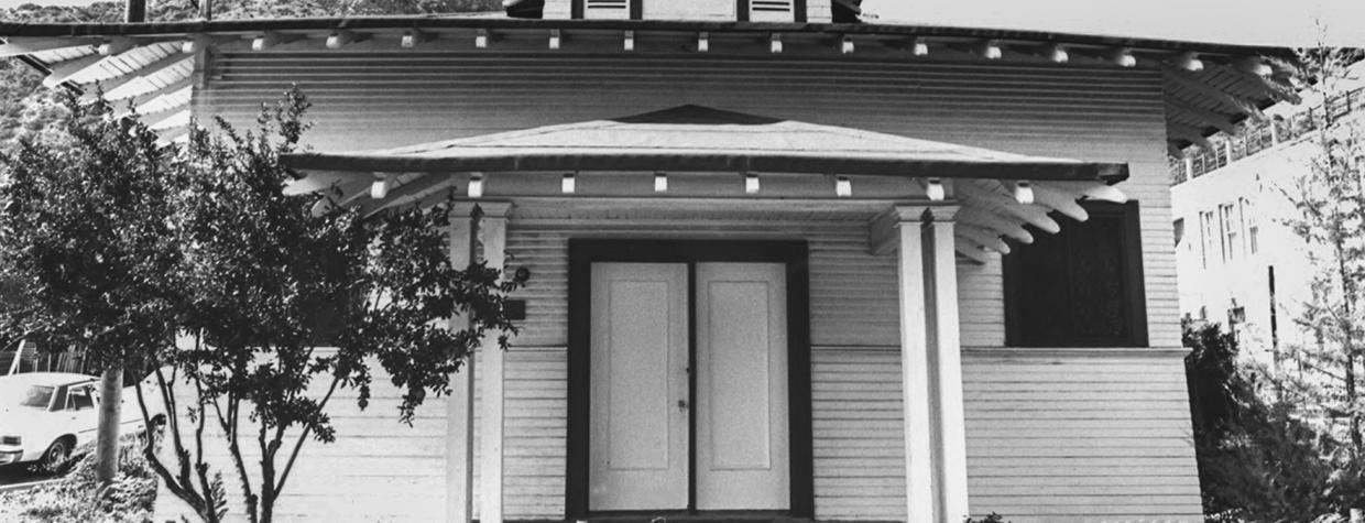 The front of the two-story Bisbee Woman’s Club’s clubhouse, dedicated in 1902, is shown behind a low wire fence. Courtesy NATIONAL PARK SERVICE