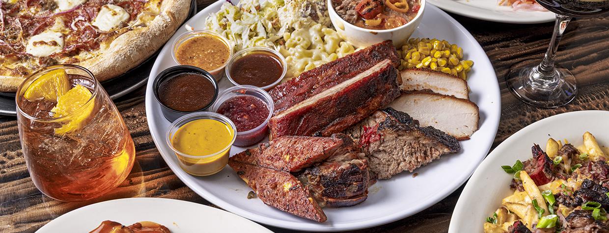 A selection of menu items available at Rim Country BBQ includes a barbecue plate, wood-fired pizza, wings, drinks and dessert.