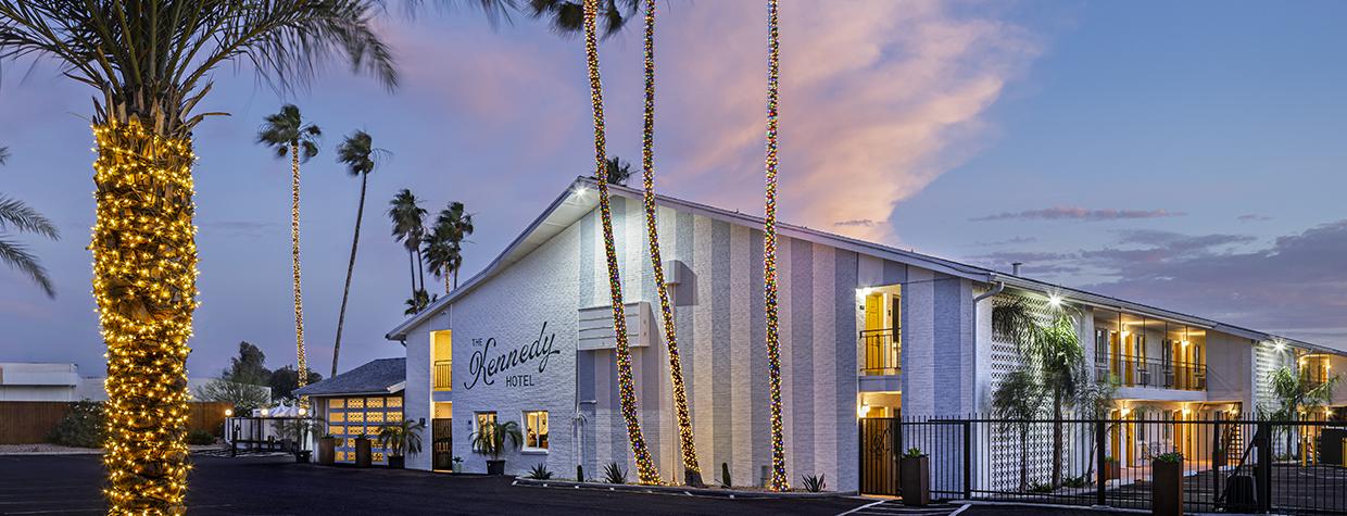 The Kennedy Hotel is pictured at twilight surrounded by lighted palm trees. By Steven Meckler