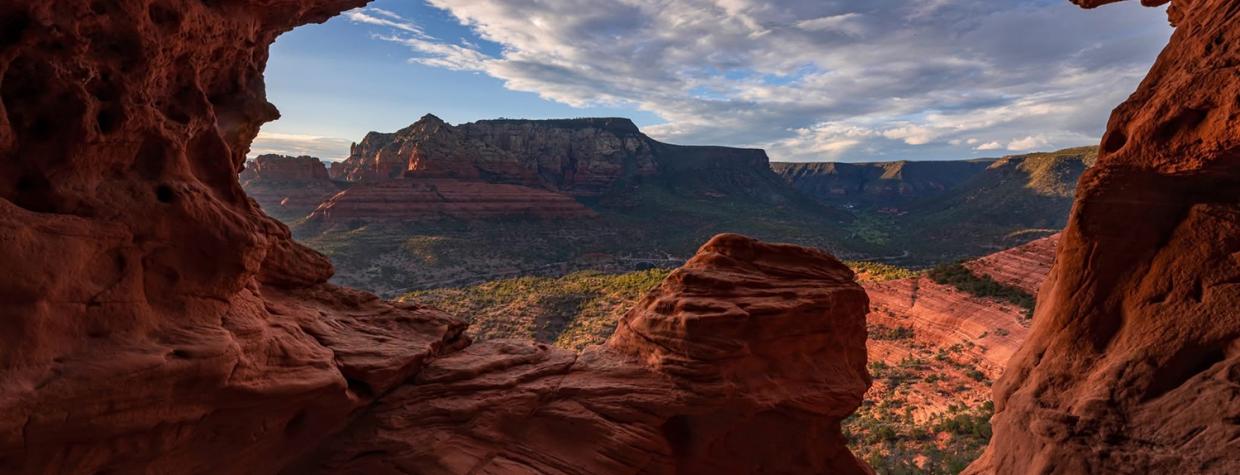 A sandstone cave near Schnebly Hill Road frames a panorama of Red Rock Country. By Chirag Patel