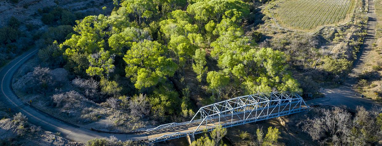 A historic bridge on Wagoner Road spans the cottonwood-lined Hassayampa River. By Rebecca Wilks