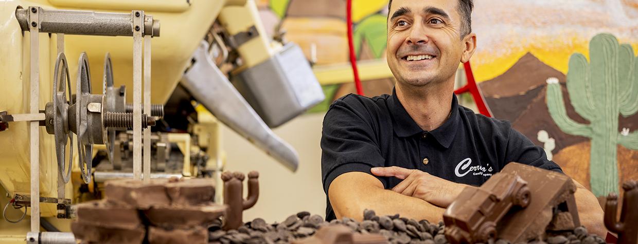 Photograph of Tony Cerreta surrounded by chocolates by Jill Richards