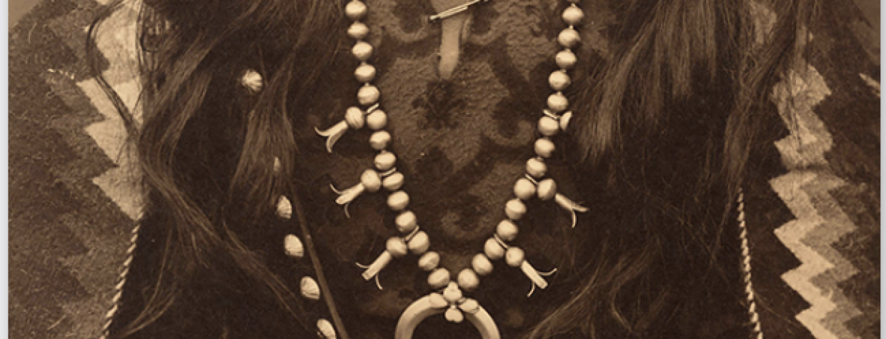 A book cover shows Navajo "Gunshooter" in a sepia toned image. He's wearing tradition clothing and a large squash blossom necklace. 