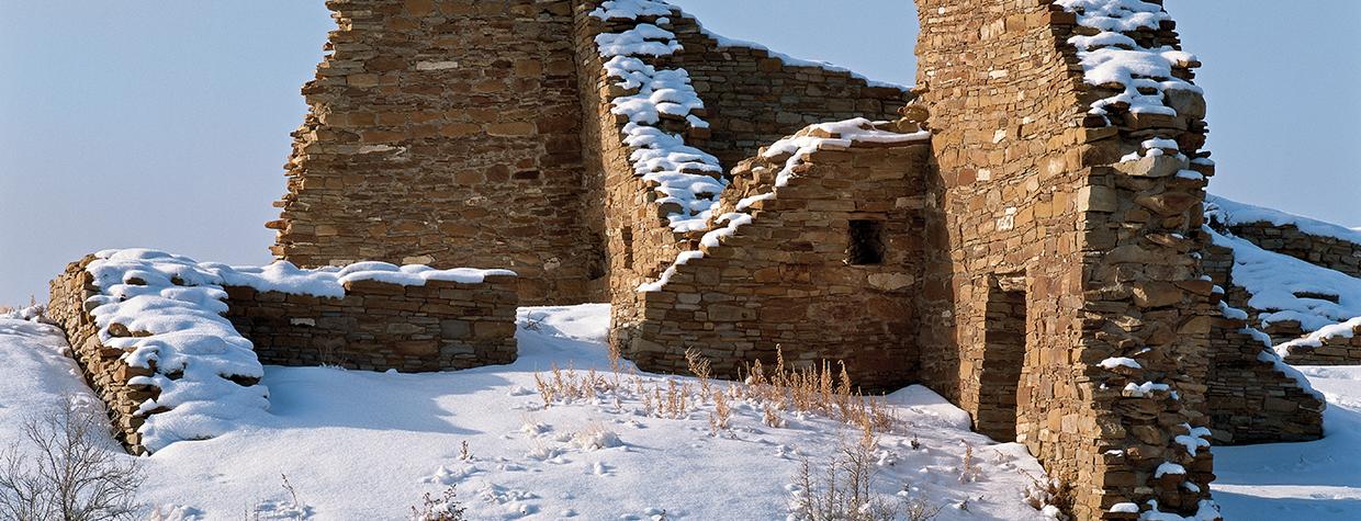 Draped in a layer of snow, Pueblo del Arroyo’s massive stone walls stand deserted in Chaco Culture National Historical Park, New Mexico. Early Southwestern dwellers left behind many clues that help historians understand ancient cultures. | George H.H. Huey