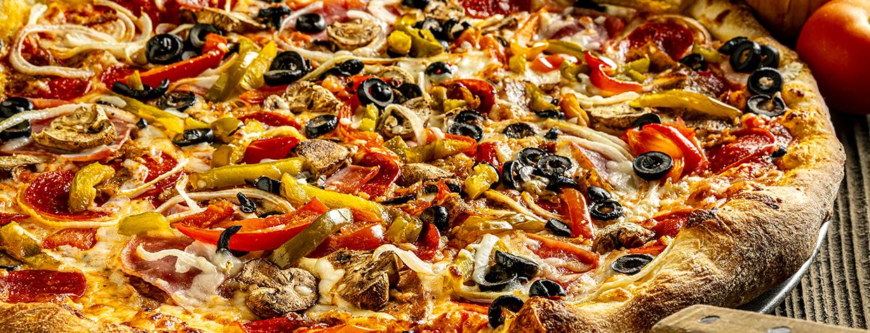 Photograph of loaded pizza is by Steven Meckler.