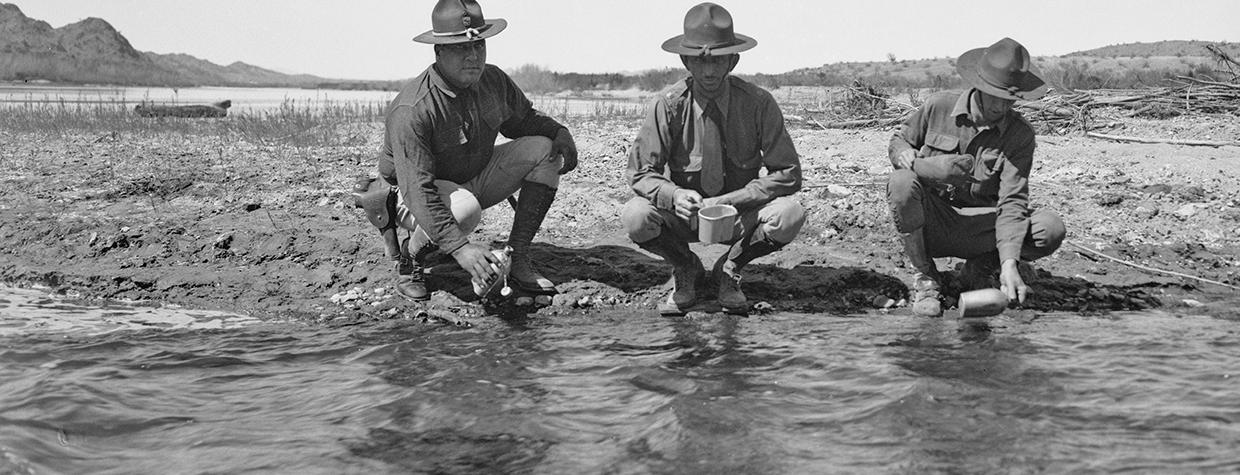 Three members of the Arizona National Guard fill their canteens with Colorado River water during a 1934 showdown with California over the construction of Parker Dam. | UCLA CHARLES E. YOUNG RESEARCH LIBRARY