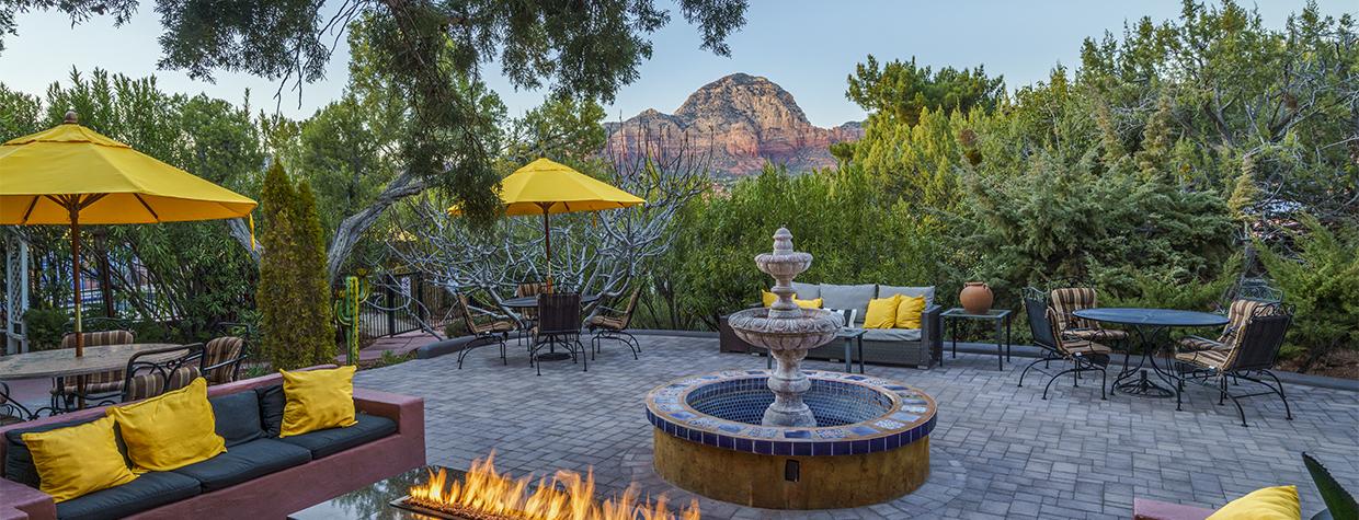 The patio area of A Sunset Chateau includes a fountain, firepit and a view of the nearby red rocks of Sedona. | Laurence Parent