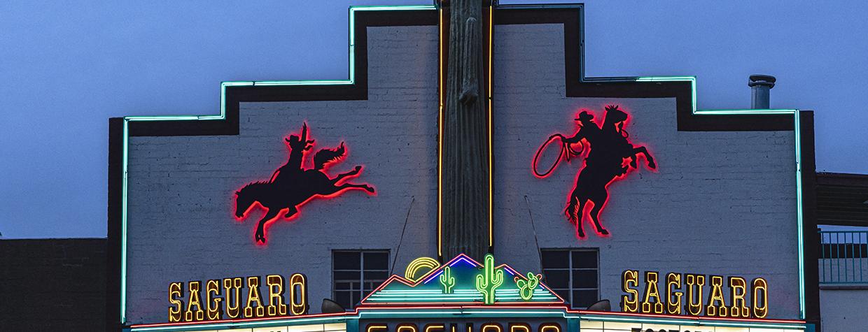 The facade of the Saguaro Theater in Wickenburg features backlit silhouetted figures of mounted cowboys in action. By Mark Lipczynski