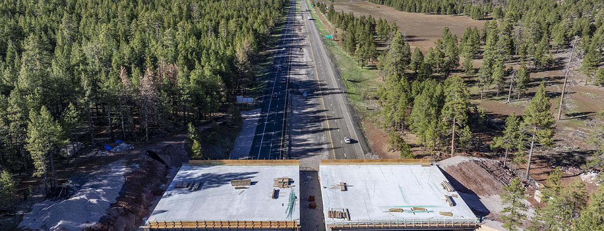 This photograph, made with a drone, shows a new wildlife bridge under construction over Interstate 17 between Munds Park and Flagstaff. | LAURENCE PARENT