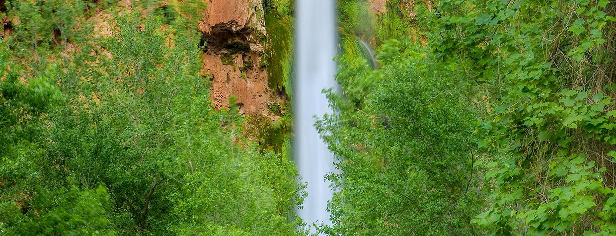 Plunging nearly 200 feet into a turquoise pool, Mooney Falls is per-haps the most dramatic cascade in the village of Supai, at the far western edge of the Grand Canyon. | Suzanne Mathia