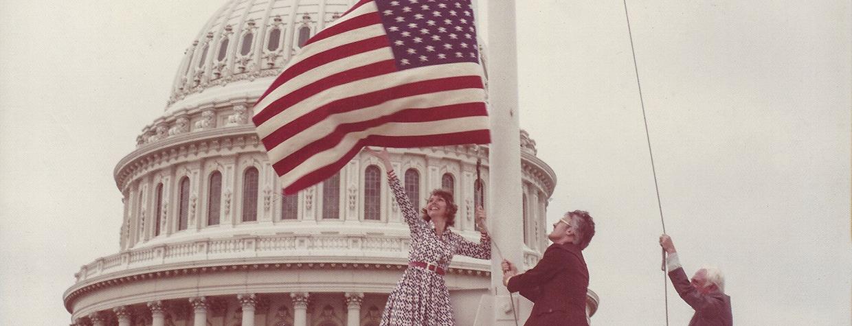 On June 14, 1976, Carolyn Hartmann (left) and Associate Editor Wes Holden (center) flew an American “flag rug” over the U.S. Capitol.