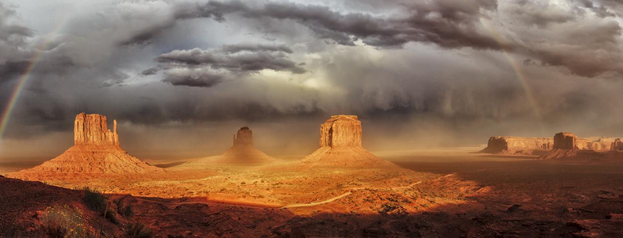 A stitched panorama of three photos made during an autumn storm at Monument Valley is by Enio Lanaro.