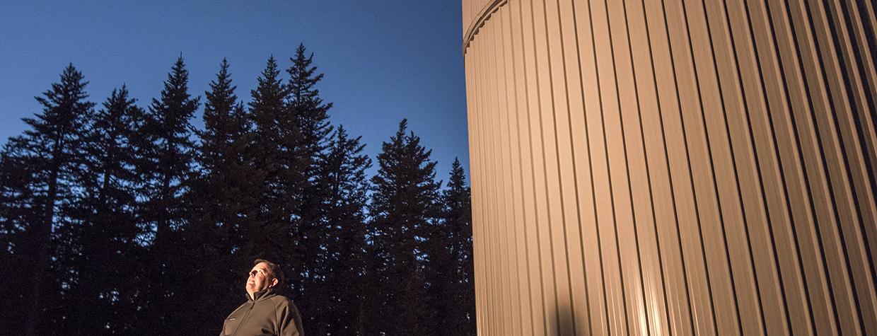 Father Paul Gabor, S.J., the vice director of the Vatican Observatory Research Group, looks to the heavens outside the Vatican Advanced Technology Telescope (VATT) building. Gabor calls the observatory atop Mount Graham “a very standard scientific institution.” | Bill Hatcher