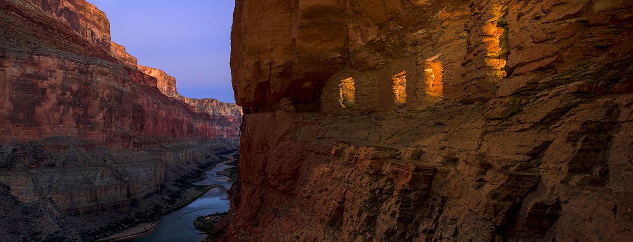 Light spills out of the Nankoweap granaries as the moon rises over the Colorado River at the Grand Canyon. | Adam Schallau
