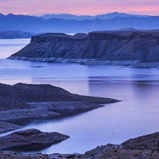 A dirt road winds toward Gregg's Hideout, a remote bay on Lake Mead, at sunset. | Larry Lindahl