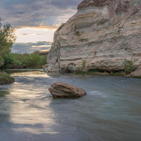 The Verde River flows past the imposing namesakes of the White Cliffs Trail. By Laurence Parent