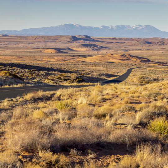 The Tse’nikani Scenic Road, a stretch of U.S. Route 191, curves through the expansive landscape of the Navajo Nation. By John Burcham