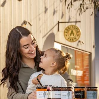 Kassi Rahman, pictured with her daughter, Piper, enjoy one of many flavors of jams. By Paul Markow