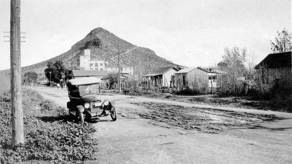 Spartan residences line Tempe’s unpaved First Street  in the 1920s. This view is looking east toward the Hayden Flour Mill and Tempe Butte, better known today as “A” Mountain. | Tempe History Museum