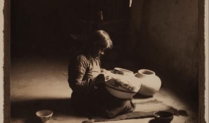 A sepia toned image shows a portrait of a young potter
