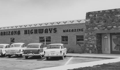 Black and white photo of Phoenix building that is home to Arizona Highways magazine, with mid-century automobiles parked in the front lot. | Arizona Highways Archives