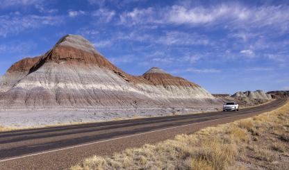Author Noah Austin navigates an electric vehicle through the Tepees, a section of Petrified Forest National Park. While Arizona’s other two national parks, Grand Canyon and Saguaro, have fast charging stations nearby, the Petrified Forest area poses challenges for EV road-trippers. | John Burcham