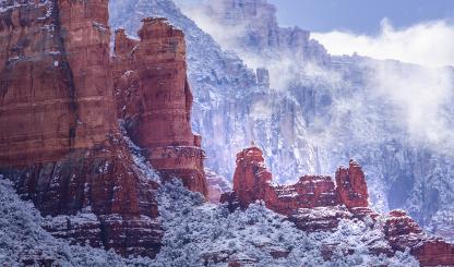 Fog and snow-covered foliage combine to form a wintry scene amid the sandstone buttes of Red Rock Country. The formations seen in the foreground are part of Snoopy Rock, named for its resemblance to the Peanuts character. | Larry Lindahl