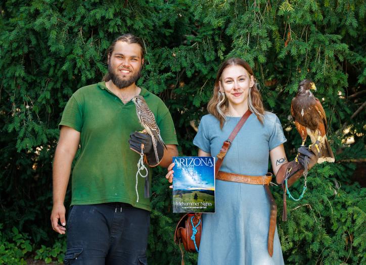 Marko and Lucia, falconers in Slovakia, pose with a copy of Arizona Highways magazine
