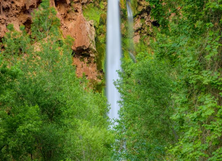 Plunging nearly 200 feet into a turquoise pool, Mooney Falls is per-haps the most dramatic cascade in the village of Supai, at the far western edge of the Grand Canyon. | Suzanne Mathia