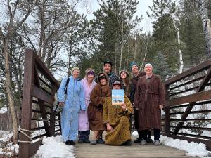 Global Snapshot at the Mt. Princeton Ht Springs Resort of 8 people posing with the November 2024 issue of Arizona Highways