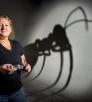 Giant ant shadow behind woman with petrie dish and forceps by Steven Meckler