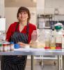 Melody Frazer in community kitchen with cooking ingredients. Photograph by John Burcham.