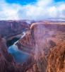 Fog and mist lift from Glen Canyon, revealing the sky reflected in the water below. By Gary Ladd