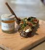 A color image shows a small jar of honey and two bite-sized snacks with fig, honey and cheese.