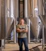 John Peasley stands near large vats at the Grand Canyon Brewing Co.