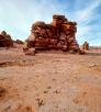  Dinosaur tracks etched in stone lead to layered rock formations in the Painted Desert. By Tom Bean