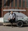 Tim Elinski stands in front of a travel trailer. By Paul Markow