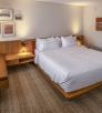 The interior of a room at Trailborn Grand Canyon features a large bed, sitting area and a desk. By John Burcham