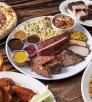 A selection of menu items available at Rim Country BBQ includes a barbecue plate, wood-fired pizza, wings, drinks and dessert.