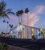 The Kennedy Hotel is pictured at twilight surrounded by lighted palm trees. By Steven Meckler