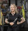 Jenna Majchrzak between bicycles and among tools at Transit Cycles, her bike shop. By Steven Meckler