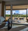 the view from inside a room at Los Milics Vineyards includes a covered patio overlooking the vineyard with a view of Mount Bruce in the distance. By Steven Meckler