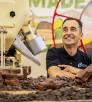 Photograph of Tony Cerreta surrounded by chocolates by Jill Richards