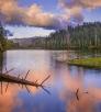 Blue sky and colorful clouds reflect off Christmas Tree Lake in Arizona's White Mountains. By Jack Dykinga
