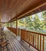 The long, wooden porch at Tal-Wi-Wi has plenty of chairs for guests to enjoy the White Mountains view. By Laurence Parent