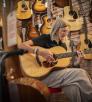 Gray Dog Music customer Julie Sullivan Brace plays one of the store’s available guitars. | Dawn Kish