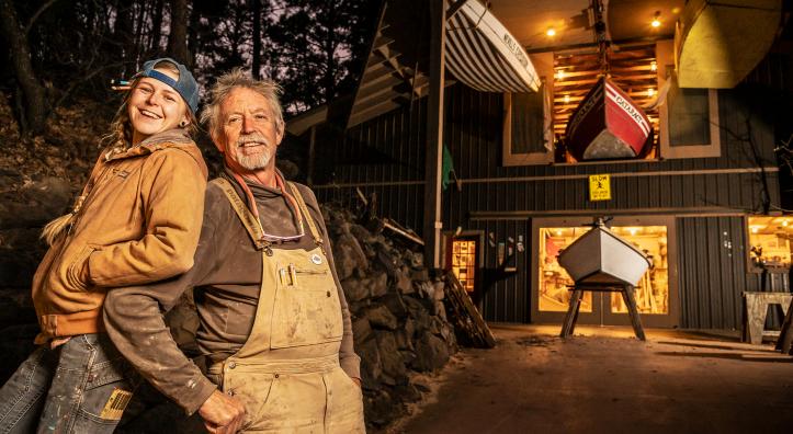 Two boatbuilders in front of their shop