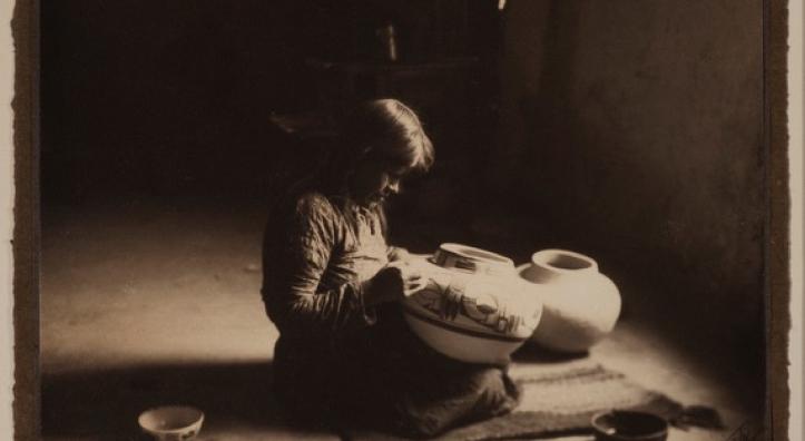 A sepia toned image shows a portrait of a young potter
