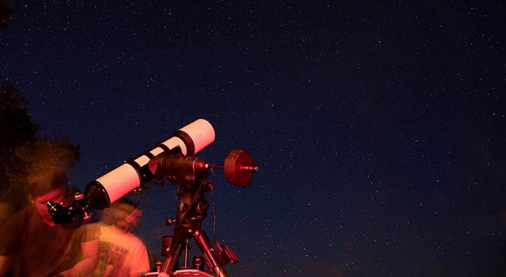 A visitor to the North Rim of Grand Canyon National Park looks through a telescope during the Grand Canyon Star Party. Photograph by John Burcham.